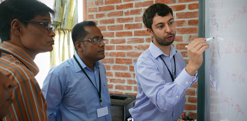 Angelos Deltsidis writing postharvest data with trainees learning about postharvest in Bangladesh