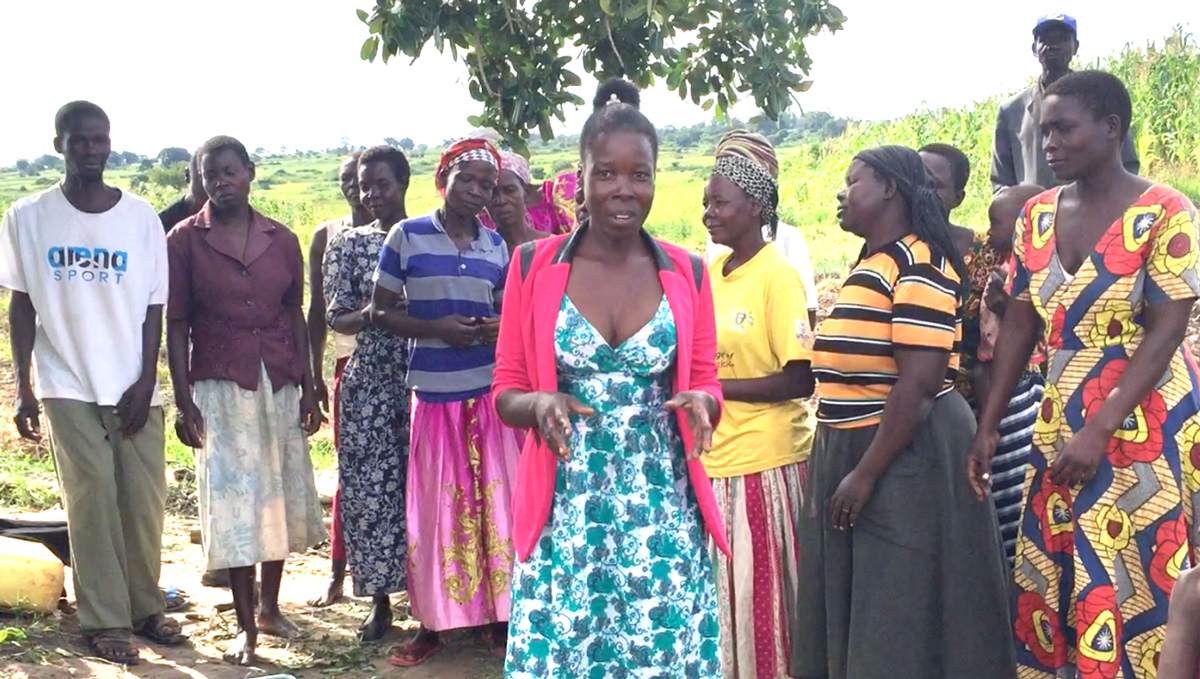 woman farmer in front of farmer group, smiling