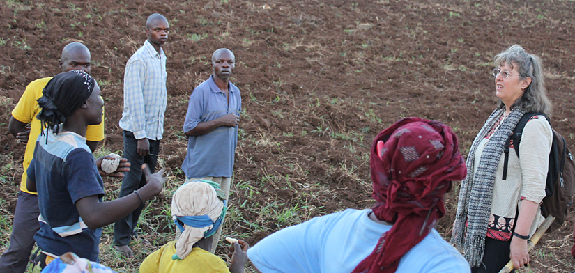 Farmers discuss needs for irrigation with Kate Scow in field