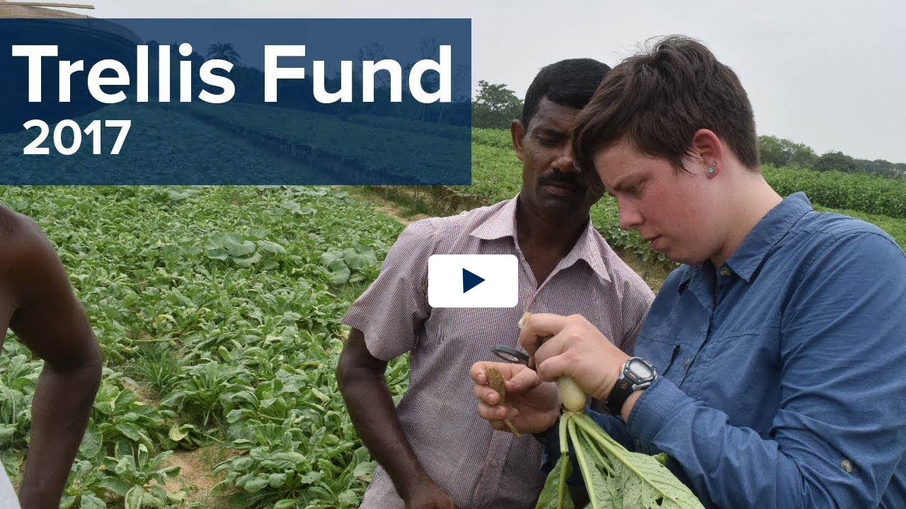 Trellis Fund 2017 text over video clip of student and Bangladeshi professional examining a vegetable in a field