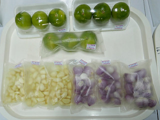 Semi-transparent and transparent small bags sit on a tray with produce inside