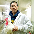 Huaijun Zhou with a chicken