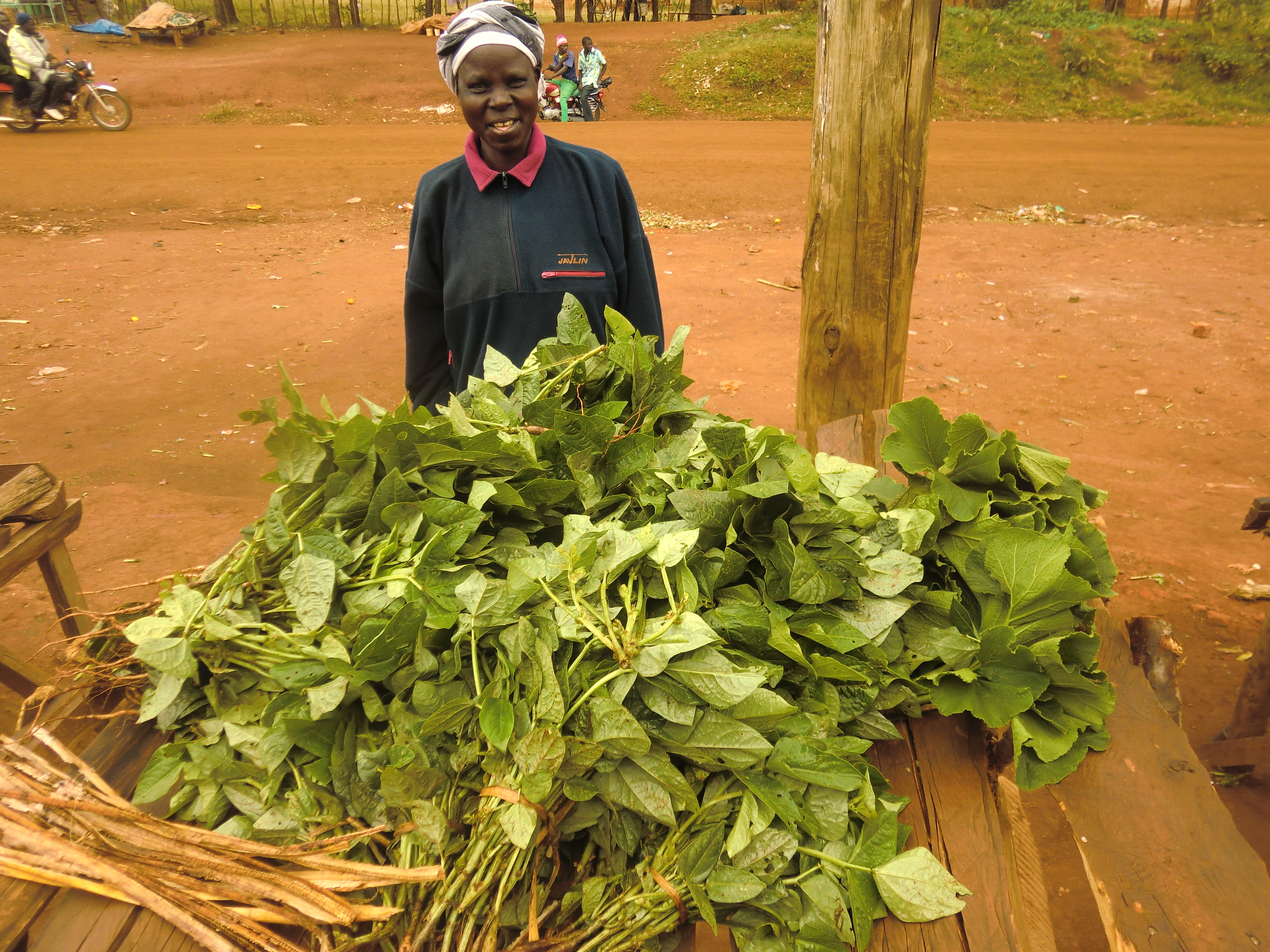 woman farmer with leafy green vegetables