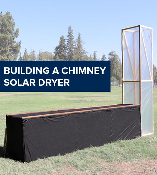 "Building a chimney solar dryer" text on image of a chimney solar dryer in a field