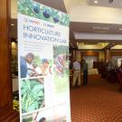 Hotel ballroom with Horticulture Innovation Lab poster in foreground